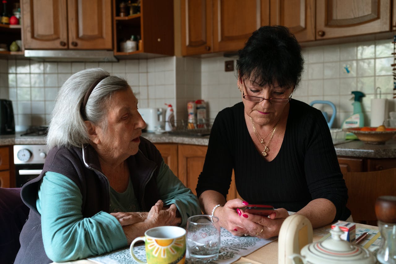 A caregiver assists an elderly man in a home environment, showcasing compassionate home care.