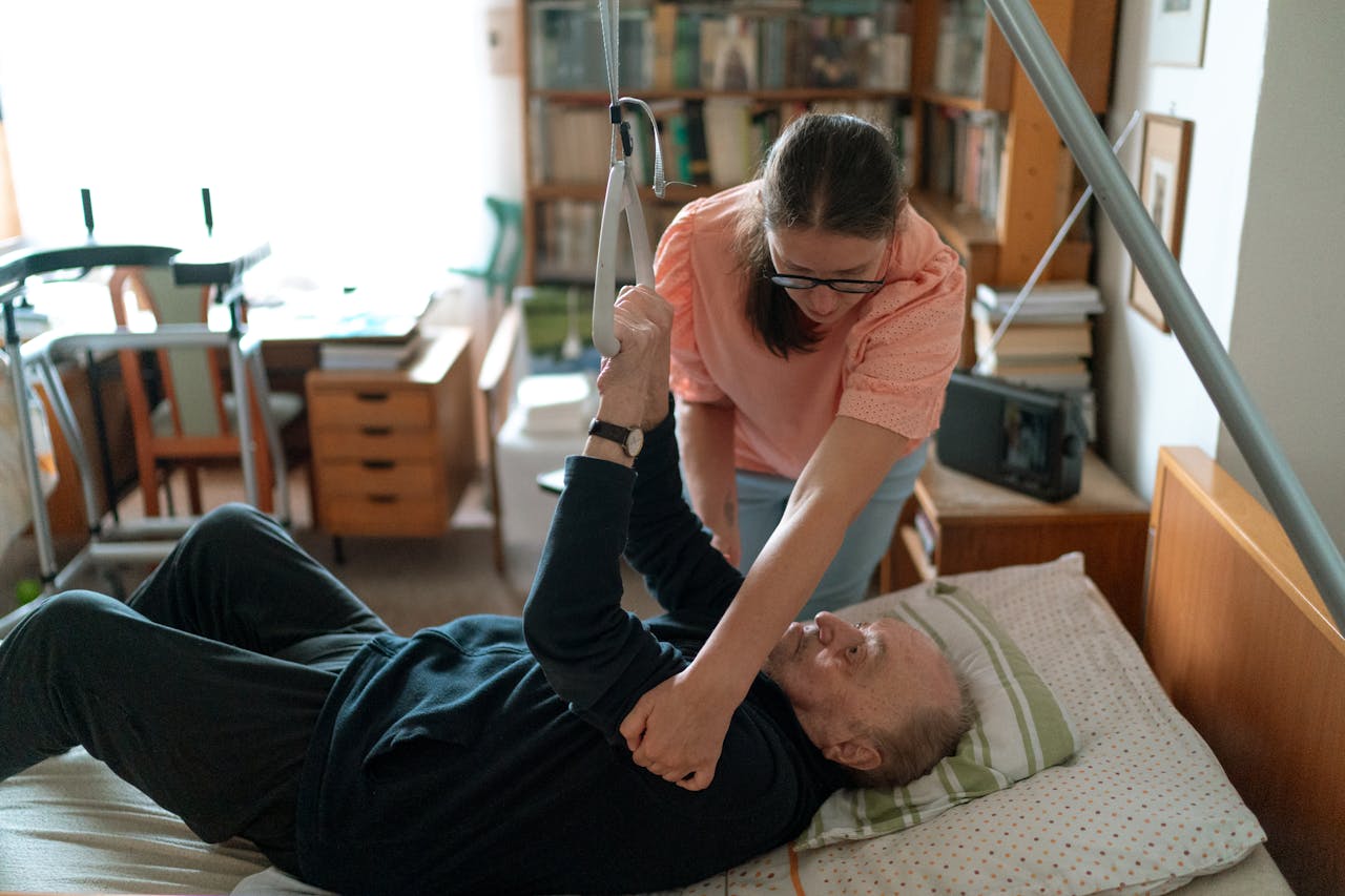 Close-up of hands passing medicine, symbolizing care and support in a nursing home.