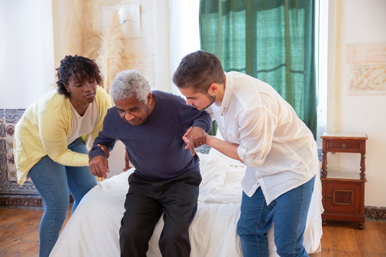 Mastering the First Impression: Your intriguing post title goes here An elderly man receiving assistance from caregivers in a cozy home environment.
